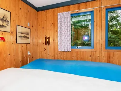 a bedroom with a blue bed and a window at 5 person holiday home in Højslev-By Traum in Bøstrup