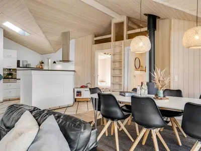 a kitchen and dining room with a table and chairs at Holiday Home Yngve - 3-5km from the sea by Interhome in Fjerritslev