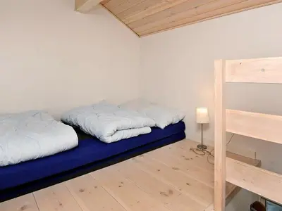 two beds in a room with a blue mattress at 8 person holiday home in Ulfborg-By Traum in Thorsminde