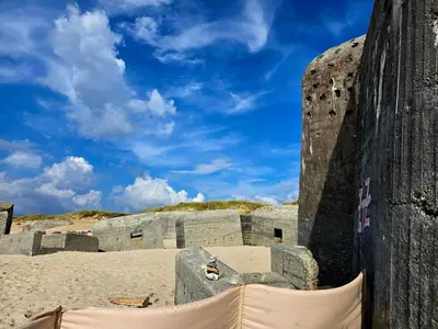 a stone building on a beach with a blue sky at 8 person holiday home in Ulfborg-By Traum in Thorsminde