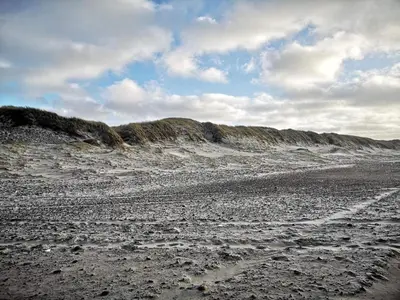 a sandy beach with footprints in the sand at 8 person holiday home in Ulfborg-By Traum in Thorsminde