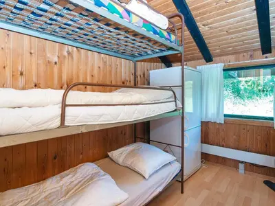 two bunk beds in a room with a window at 7 person holiday home in Lemvig-By Traum in Lemvig