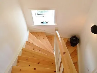 a staircase in a house with a window at 5 person holiday home in Harboøre in Harboør