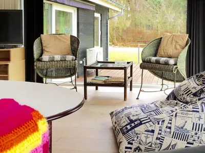 a living room with two chairs and a coffee table at 6 person holiday home in Spøttrup-By Traum in Knud