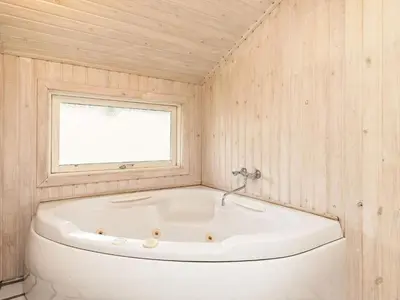 a white tub in a room with a window at 8 person holiday home in Pandrup-By Traum in Blokhus
