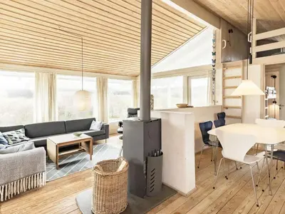 a living room with a couch and a table at 8 person holiday home in Pandrup-By Traum in Blokhus