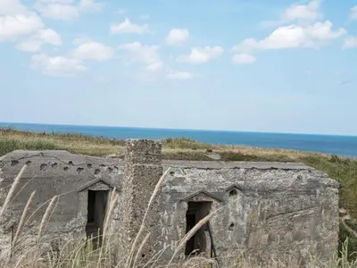 an old building on the side of a beach at 4 person holiday home in Lemvig-By Traum in Trans