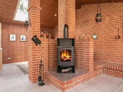a brick wall with a fireplace in a room at 6 person holiday home in Hurup Thy-By Traum in Sindrup