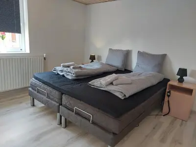 a large bed with two pillows on it in a room at Venos Home in Lemvig