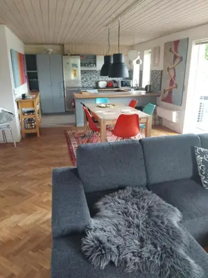 a living room with a couch and a table at Dejligt og stort hus med spa og sauna in Roslev