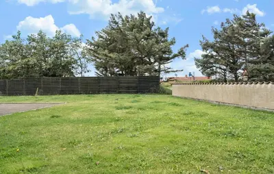 a large yard with a fence and trees at Stunning Home In Harboøre With Wifi in Harboør