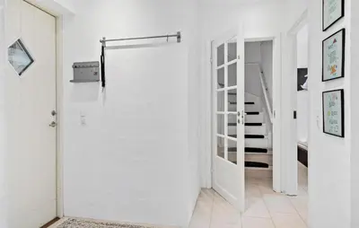 a white hallway with a door and stairs at Stunning Home In Harboøre With Wifi in Harboør