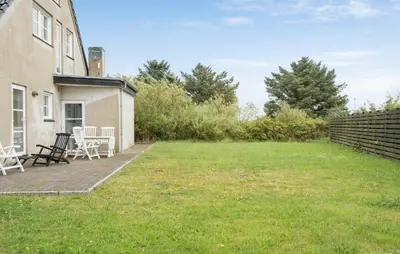 a yard with chairs and a house at Lovely Home In Harboøre With Wifi in Harboør