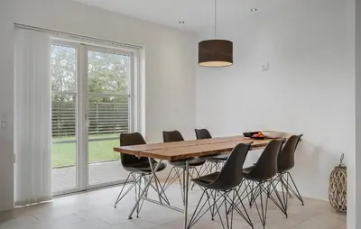 a dining room with a wooden table and chairs at Lovely Home In Harboøre With Wifi in Harboør