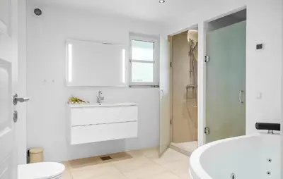 a white bathroom with a sink and a tub at Lovely Home In Harboøre With Wifi in Harboør