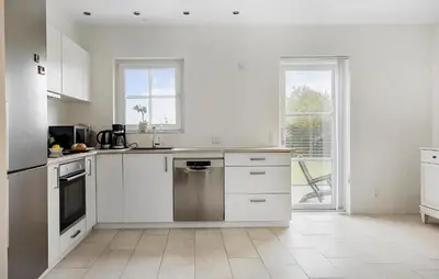 a white kitchen with white cabinets and a window at Lovely Home In Harboøre With Wifi in Harboør