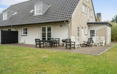 a patio with a table and chairs in front of a house at Lovely Home In Harboøre With Wifi in Harboør