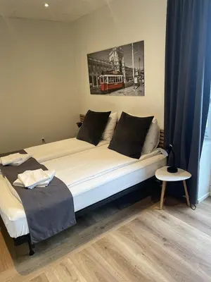 a large bed in a room with at Hotel Tante in Lemvig