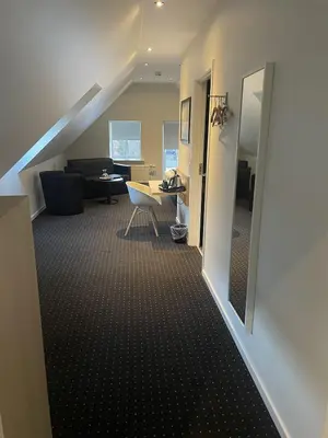 a room with a staircase with a living room at Hotel Tante in Lemvig