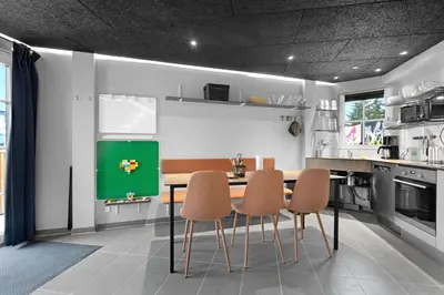 a kitchen with a table and chairs in it at Funart 10 in Pandrup