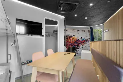 a dining room with a wooden table and chairs at Funart 10 in Pandrup