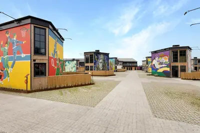 a group of buildings with graffiti on them at Funart 8 in Pandrup