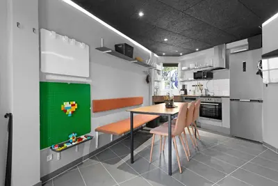 a kitchen with a table and some chairs and a tableablish at Funart 8 in Pandrup