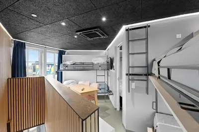 a dorm room with a desk and bunk beds at Funart 14 in Pandrup