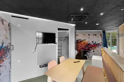 a conference room with a table and a tv on a wall at Funart 14 in Pandrup