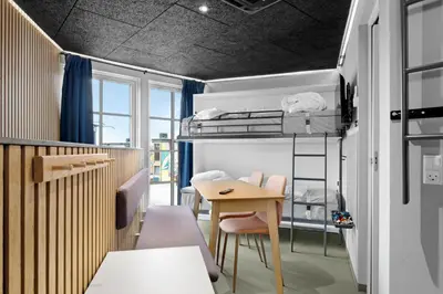 a room with a bunk bed and a table at Funart 11 in Pandrup