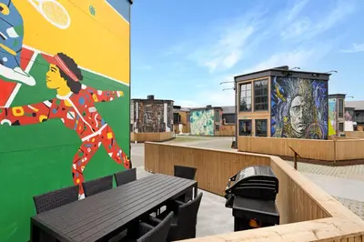 a building with a mural and a bench on the roof at Funart 12 in Pandrup
