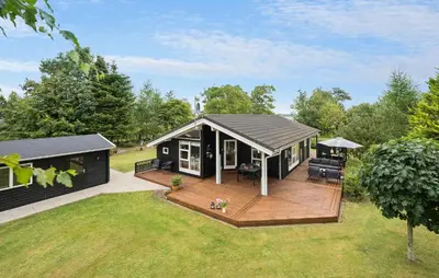 a black modular house with a deck on a yard at 2 Bedroom Cozy Home In Højslev in Højslev