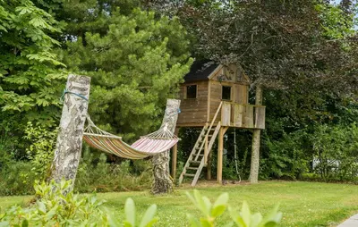 a hammock in front of a tree house at 2 Bedroom Cozy Home In Højslev in Højslev