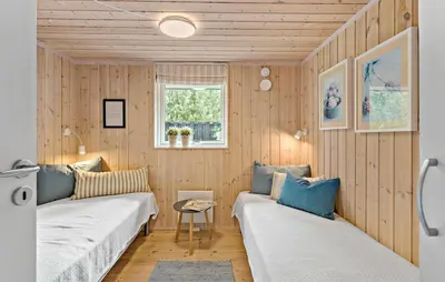 a small room with two beds and a window at 2 Bedroom Cozy Home In Højslev in Højslev