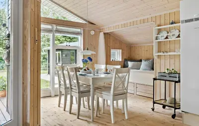 a kitchen and dining room with a table and chairs at 2 Bedroom Cozy Home In Højslev in Højslev