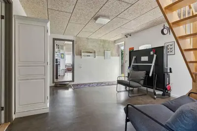 a living room with a couch and a chair at Spacious Holiday Home With Views Over Limfjorden in Jørsby