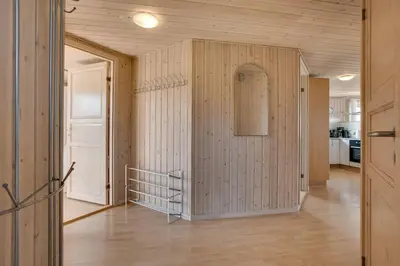 a room with wooden walls and a hallway with a door at 4 bedrooms and a beautiful view in Vinderup