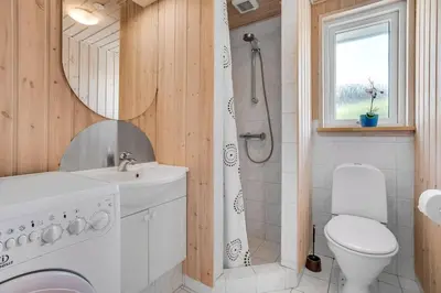 a bathroom with a shower and a toilet and a sink at 4 bedrooms and a beautiful view in Vinderup