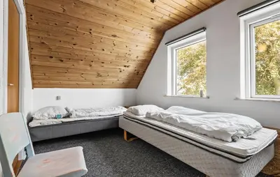 two beds in a room with two windows at Lovely Home In Bøvlingbjerg With Wifi in Bøvlingbjerg
