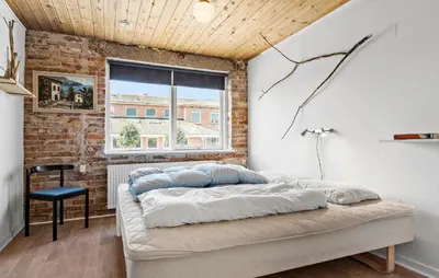 a bed in a room with a brick wall at Lovely Home In Bøvlingbjerg With Wifi in Bøvlingbjerg