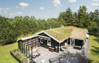 an overhead view of a house with a grass roof at Holiday Home Blokhus With Sauna 156 in Blokhus