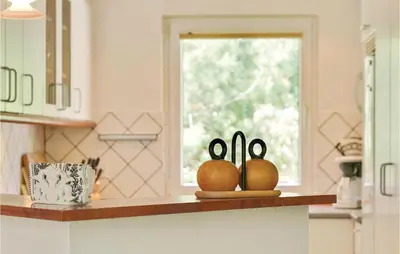 two rabbits on a counter in a kitchen with a window at Holiday Home Blokhus With Sauna 156 in Blokhus