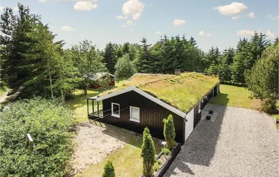 an overhead view of a house with a grass roof at Holiday Home Blokhus With Sauna 156 in Blokhus