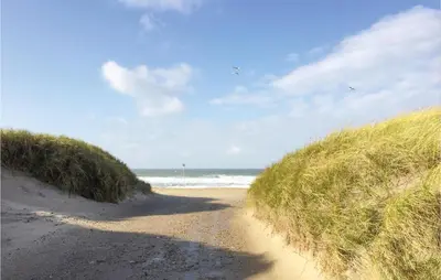 a dirt road leading to a beach with the ocean at Holiday Home Vestervig With A Fireplace 164 in Vestervig