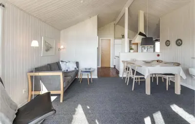 a living room with a couch and a table at Holiday Home Vestervig With A Fireplace 164 in Vestervig