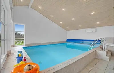 a large swimming pool in a room with a large window at 3 Bedroom Amazing Home In Vinderup in Vinderup