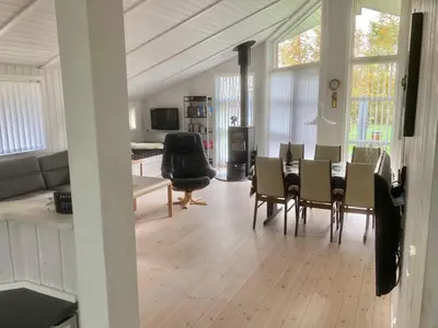 a living room with a dining room table and chairs at Family Beach Retreat - By Traum Ferienwohnungen in Løgstør