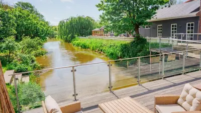 a view of a river from a balcony at Morup Mølle Kro in Bedsted Thy