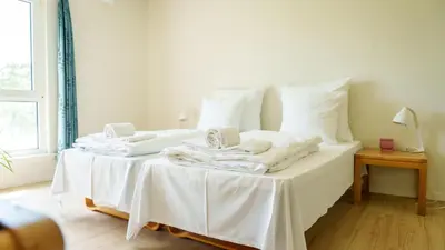 a white bed with white sheets and pillows on it at Morup Mølle Kro in Bedsted Thy