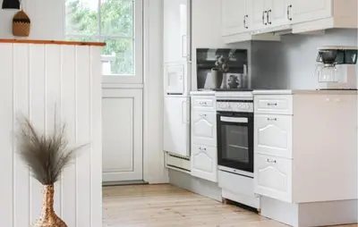 a kitchen with white cabinets and a stove at 3 Bedroom Beautiful Home In Thyholm in Thyholm